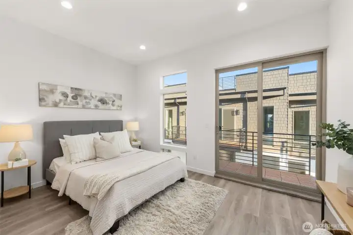 Photos of Model Home. Expansive primary suite with space for a king bed, lounge chair, and personal touches, offering a private sanctuary above the city.