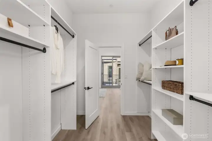 Photos of Model Home. Walk-in closet outfitted with custom shelving, drawers, and abundant hanging space—organized living made effortless.