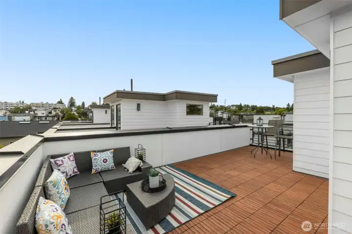Expansive rooftop deck designed for sunset soirees, weekend barbecues, and year-round entertaining against the backdrop of Seattle.