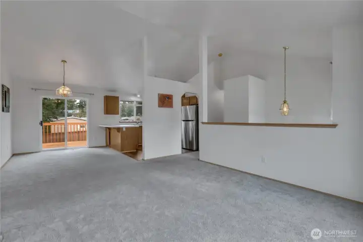 open living/dining room with vaulted ceilings.