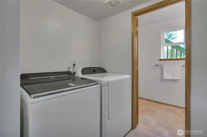 Laundry room with newer washer and dryer.