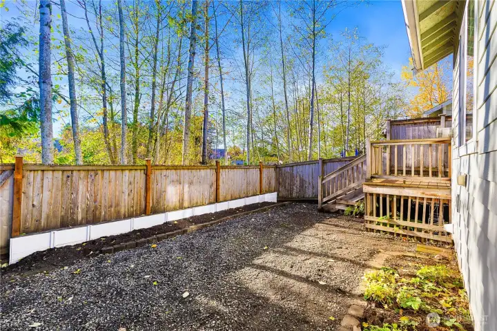 Private backyard bordered by a lush greenbelt, is ready for your landscaping creativity and your green thumb.
