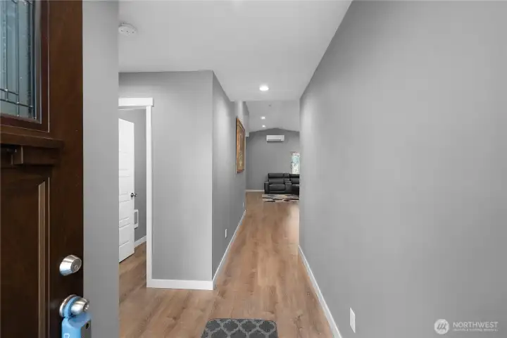 Entry hallway, guest bathroom to the left.