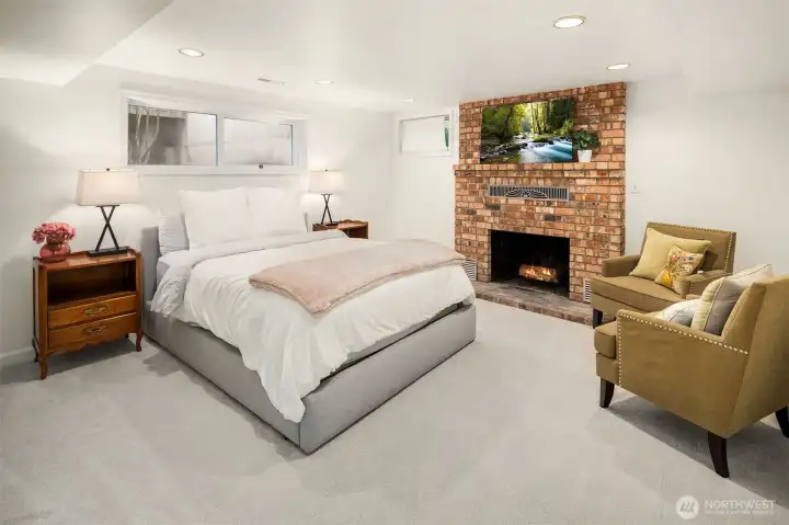 Head downstairs to the primary suite, with its own wood burning fireplace