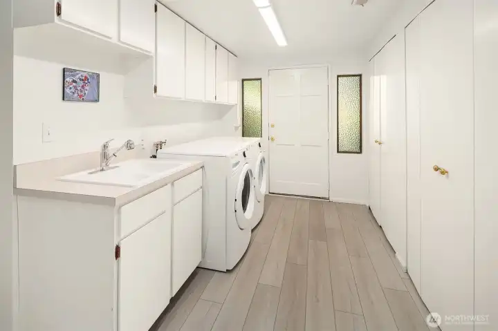Utility room downstairs includes washer/dryer, extra storage, and second entrance to side yard