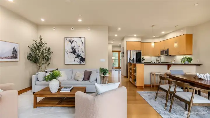 The open floor plan has bamboo floors, and open spaces to the living room, dining room and kitchen.