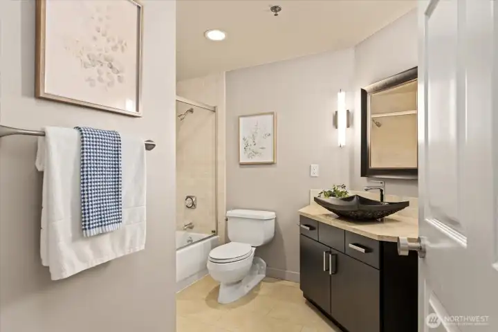 A well appointed secondary bathroom works for everyone.  The laundry closet is just to the left in the hall.