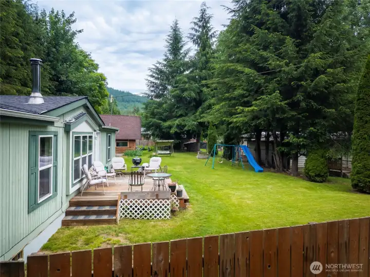 Fully fenced yard with sun deck.