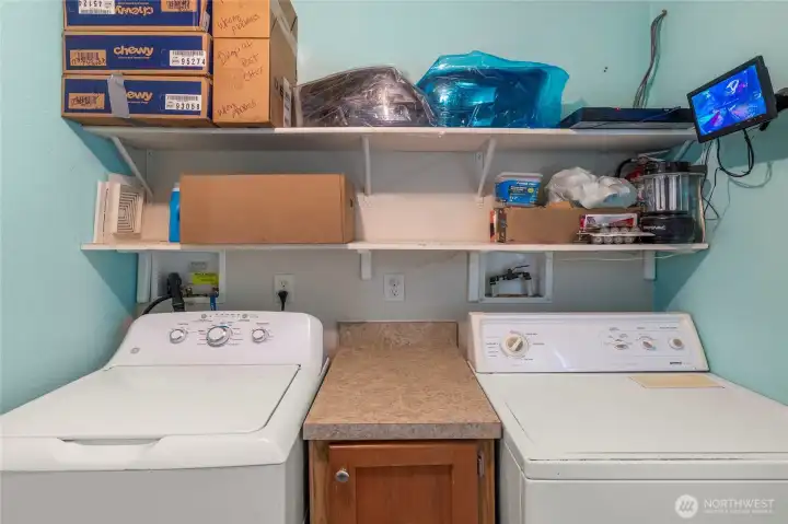 Plenty of storage in this large utility room.