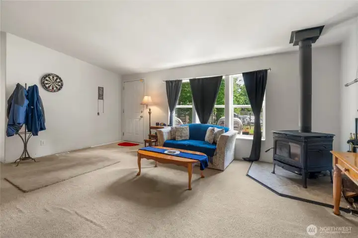 Vaulted ceilings, wood burning stove and front door to sun deck.
