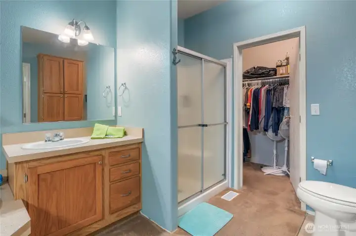 Large walk-in closet in primary bath suite.