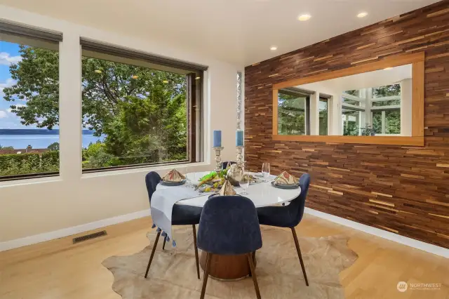 The dining room, next to the kitchen, enjoys a fun wood wall reminiscent of the natural interior elements including the architectural staircase.