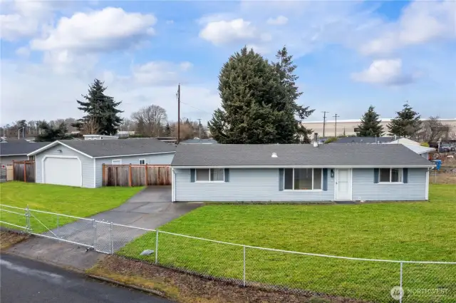 A solid and inviting home with a fully fenced yard, offering privacy and a great first impression.