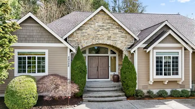 Grand Entry Features Stone Accents~Double Door~Curved Transome & Side Windows~Ring Doorbell & Leviton Security System~Step Inside to One of a Kind Quality Craftsman Home~Traditional Excellence~