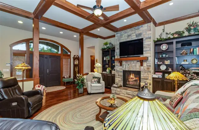 Box Beam Ceilings 12 feet in Height Set the Commanding Style of the Living Space~Built in Bookcases~Custom Stone Hearth & Gas Fireplace~Gleaming Hardwood~