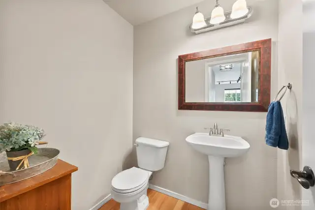 Half bath on main level with pedestal sink.