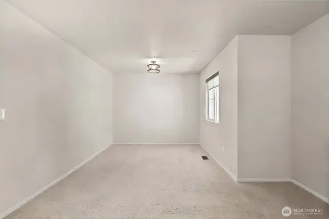 Bonus room on upper level. Photo has been digitally decluttered.