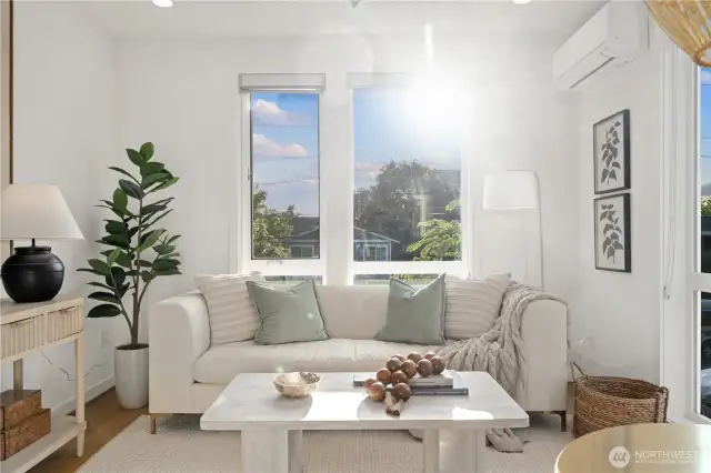 West facing living room is flooded with sunlight and a great spot to entertain guests. This end unit offers windows on two sides, making the space light and bright.