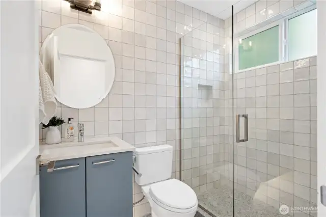Well appointed upper level bathroom with frameless shower door, heated floors, and quartz counter.