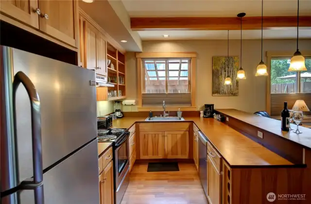 Full sized kitchen with dishwasher and plate ware.  Toaster, microwave, blender, cookware.  Everything a guest would need to feel at home.