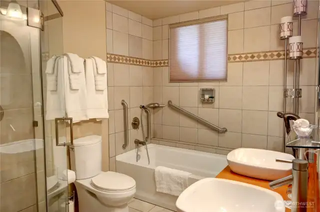 Your primary bedroom ensuite bathroom is spacious and accommodating.  Safety rails in place, deep soaking tub, tiles shower, double sinks.