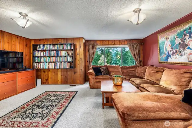 The family room offers a spacious, light-filled setting with a relaxed flow and views of the surrounding greenery. It’s a flexible area that can easily adapt to everyday living or entertaining.