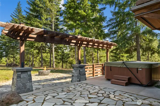Outdoor patio with hot tub and fire pit