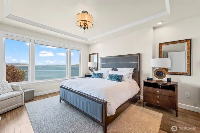 In this Primary suite you will find fully wrapped windows and electric blinds. Additionally, this is showing a king-size bed with plenty of space for the oversize nightstands.