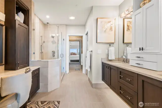 Completely customized bathroom features a vanity, dual sinks, center storage, nightlight under the floating cabinets and comforting heated floors.