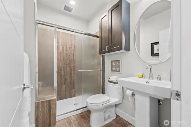 The third bathroom for use so guests don't have to walk through a bedroom to access facilities.  All baths have high-boy elongated toilets, and tile surrounds.