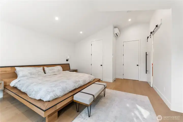 Primary bedroom High vaulted ceilings throughout the top floor; for perspective the entry door in the middle of the frame is 8'.