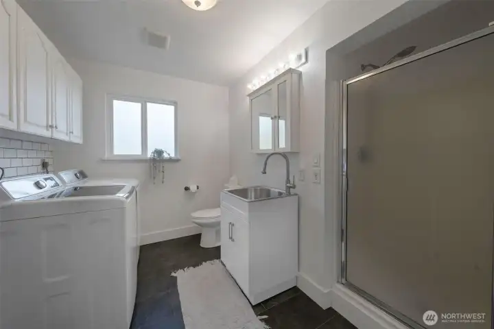 Utility room with Farmers sink and shower.