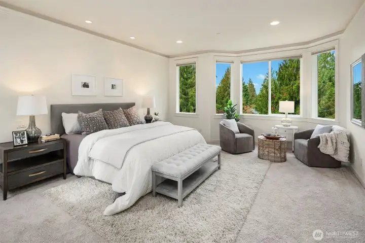 spacious primary with a view out over the backyard and beyond