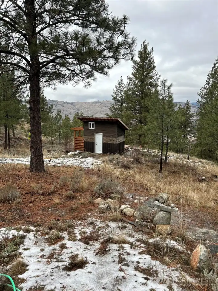 Bathhouse with shower and on-demand water heater.