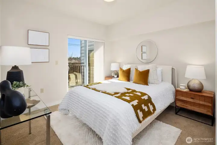 Primary bedroom with ensuite bath, walk-in closet, and deck access.
