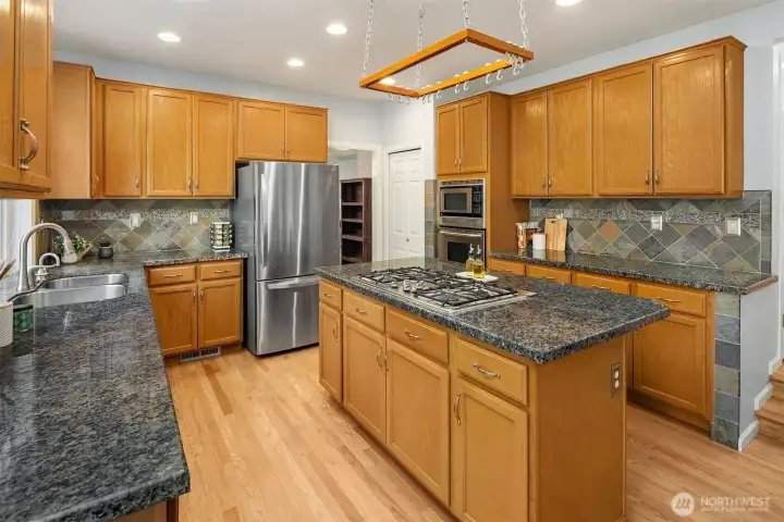 Kitchen with granite countertops, ample cabinet storage and pantry