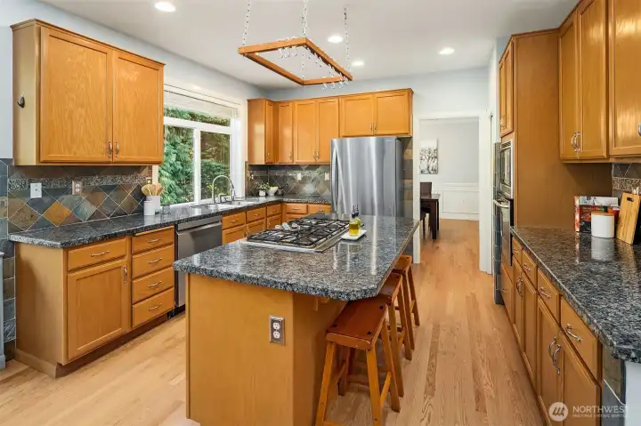 Kitchen with large window overlooking back yard