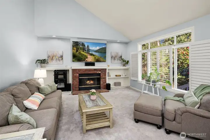 Family room features large picture windows and custom built-ins