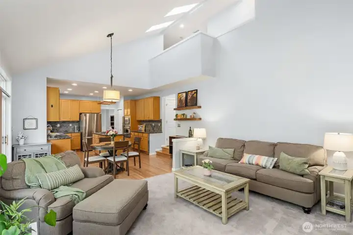 Family room overlooking hallway that leads to laundry room and half bath