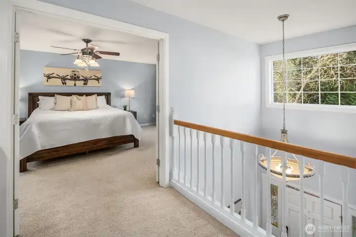 On upper level, french doors lead to spacious primary bedroom
