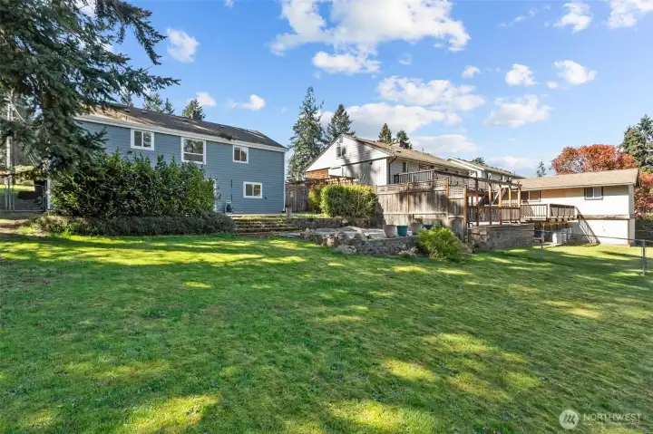 Look at this great, lush yard! And look at the privacy trees between the upper patio and the yard... giving you great entertaining space separate for the yard.