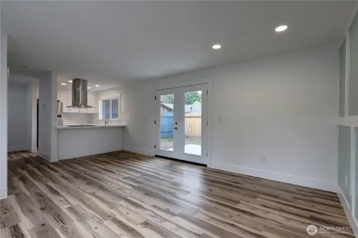 Spacious great room with easy indoor-outdoor access through French doors.