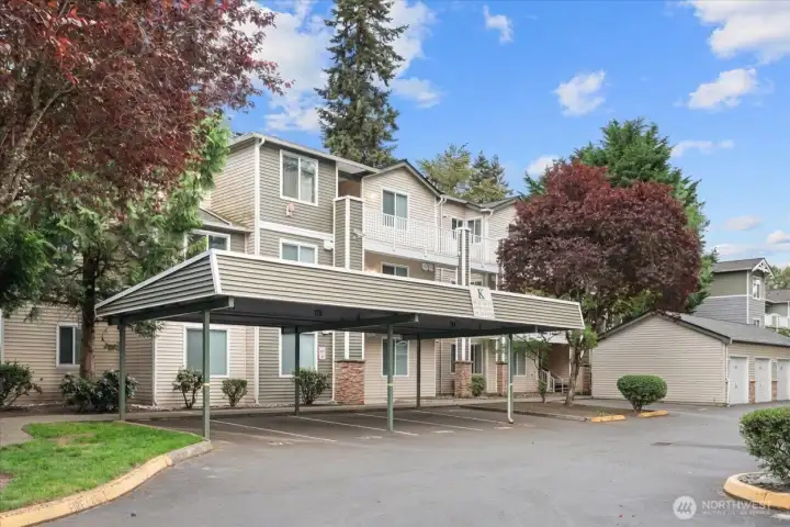 Welcome home! End unit condo with carport + private garage!