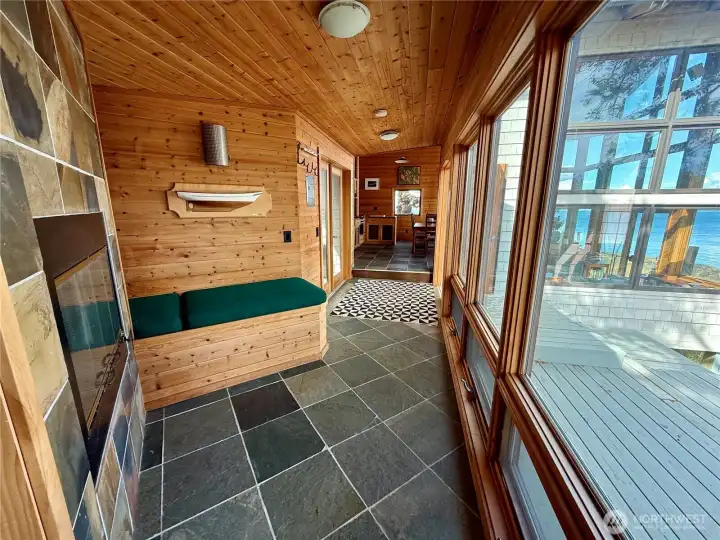 Entryway hall with seating and wood fireplace. Entryway hall with seating and wood fireplace.
