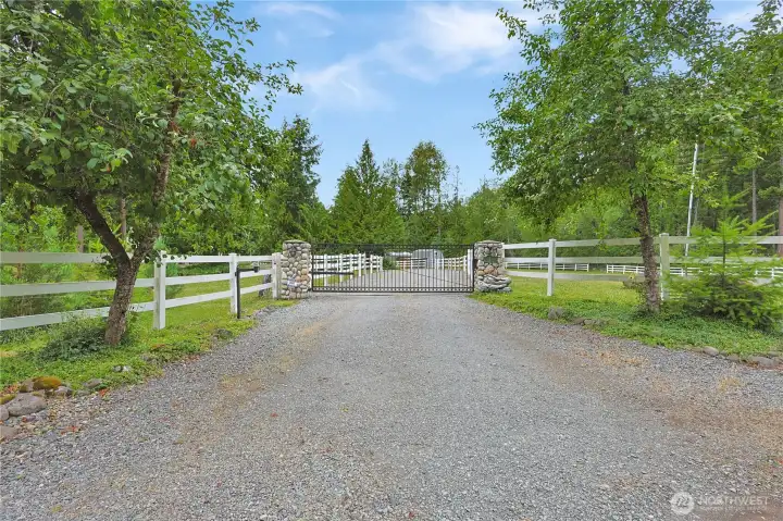 Tree lined and gorgeous gated drive - those are producing apple trees!