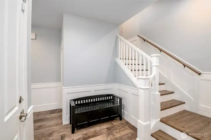 Front entry and stairs to upper floor, with LVP flooring Front entry and stairs to upper floor, with LVP flooring