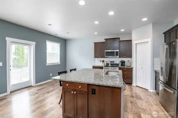 Kitchen with huge island and bar stools. Easy access to the fully fenced backyard. Kitchen with huge island and bar stools. Easy access to the fully fenced backyard.