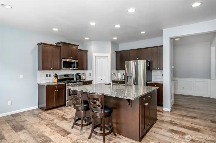 Kitchen with granite countertops and stainless steel appliances that stay with the home. Kitchen with granite countertops and stainless steel appliances that stay with the home.