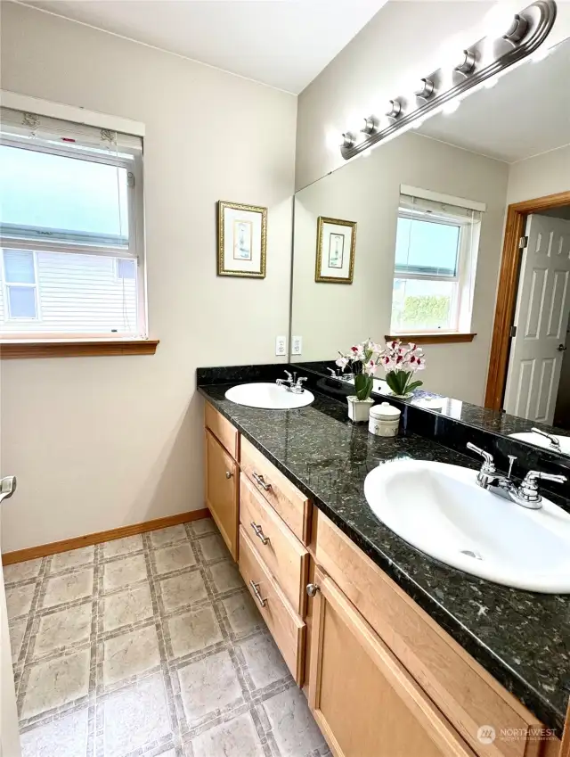 Upstairs bathroom with double sink and bathtub/shower