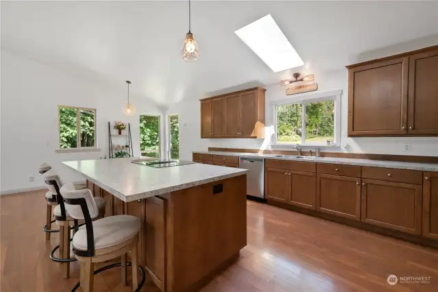 Turning to the right, you'll find a spacious kitchen bathed in sunlight, featuring a large island at its center.